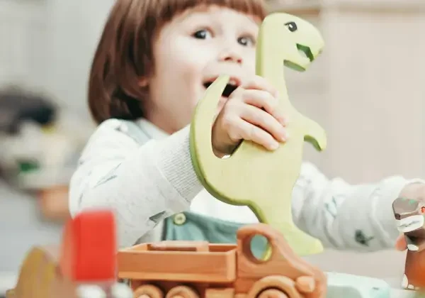 Toddler playign with wooden animals